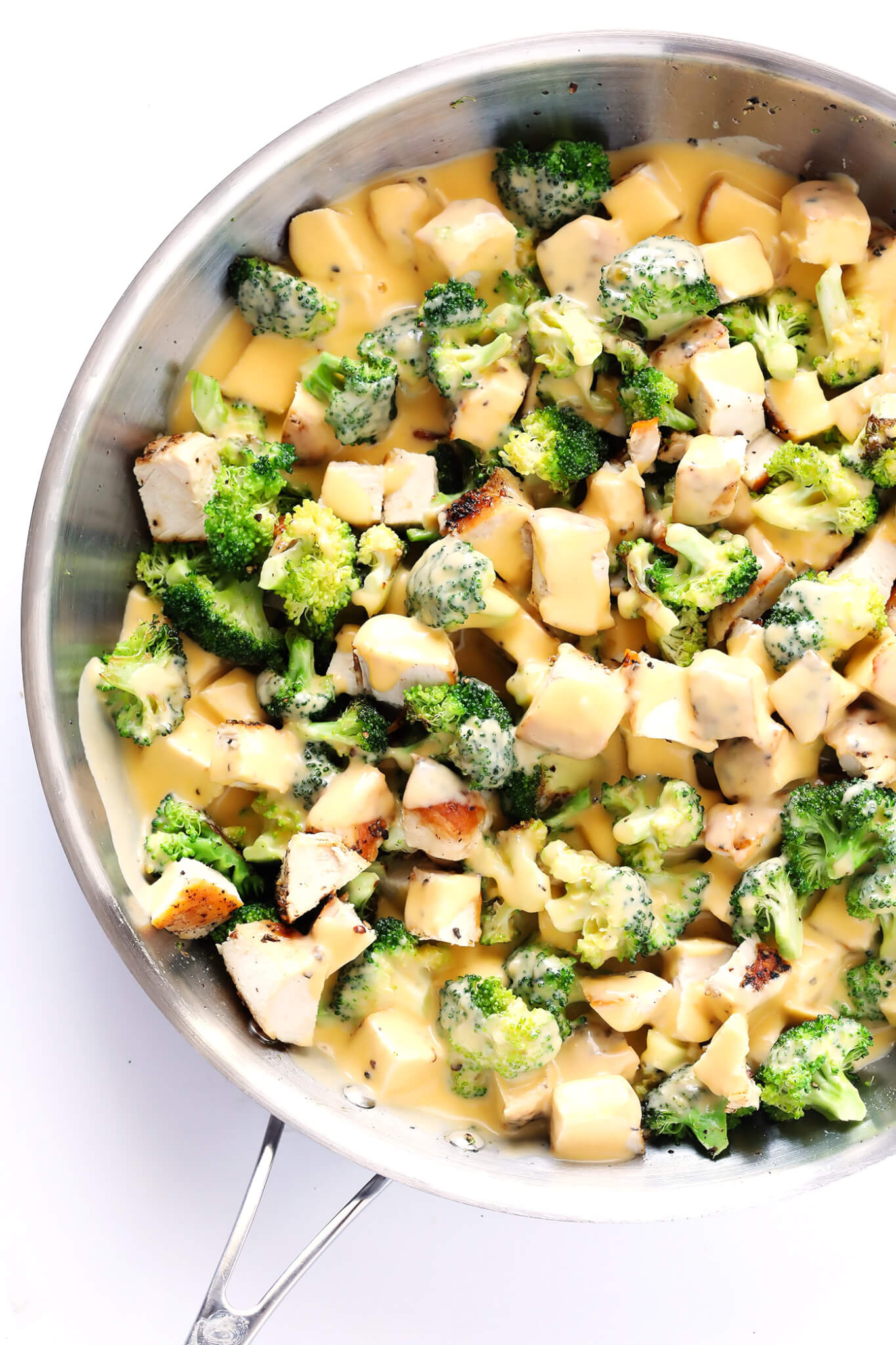 These Cheesy Broccoli, Chicken and Rice Bowls are perfect for easy meal prep or weeknight dinner, they're tossed with a lightened-up garlicky cheddar cheese sauce, and they're totally savory and delicious! Feel free to serve with rice or quinoa. | gimmesomeoven.com