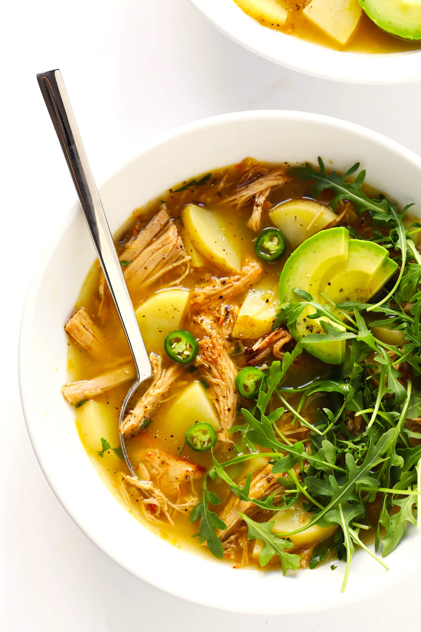 This 5-Ingredient Carnitas Soup is super-easy to make with leftover pork (or chicken) carnitas, potatoes, and salsa verde. I highly recommend loading it up with lots of toppings too, such as arugula, avocado, cilantro and jalapeño peppers. It's the perfect Mexican dinner that's easy to make on the stovetop, or in the Crock Pot (slow cooker) or Instant Pot (pressure cooker). And it's naturally gluten-free! | Gimme Some Oven