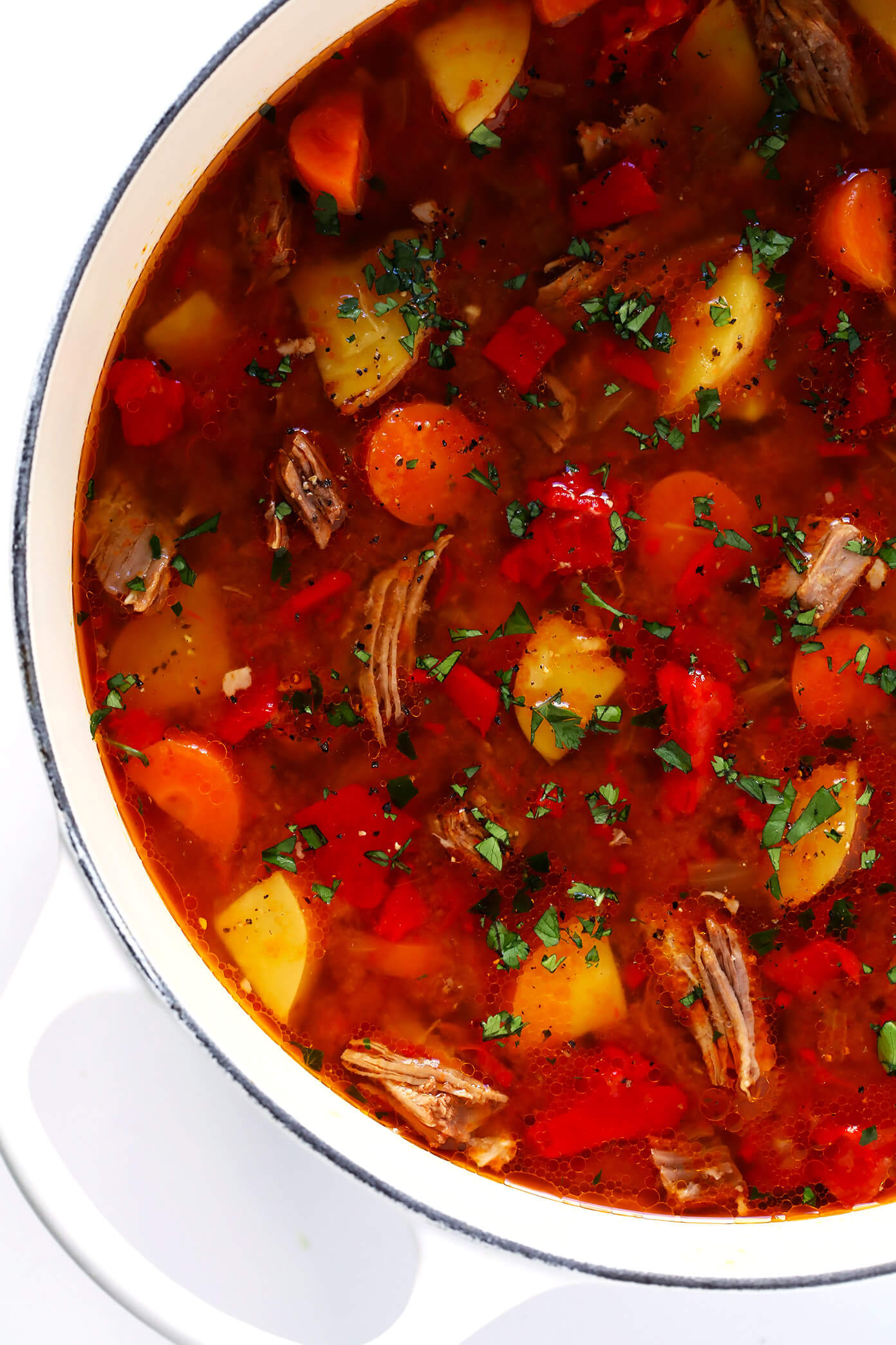 LOVE this Mexican Vegetable Beef Soup recipe! It's easy to make in the Instant Pot (pressure cooker), Crock-Pot (slow cooker), or on the stovetop. And it's full of tender steak, potatoes, carrots, roasted red peppers, tomatoes, and simmered in a delicious tomato chile broth. High recommend topping this stew with lots of fresh cilantro and avocado! #instantpot #soup #stew #pressurecooker #crockpot #slowcooker #comfortfood #beef #steak