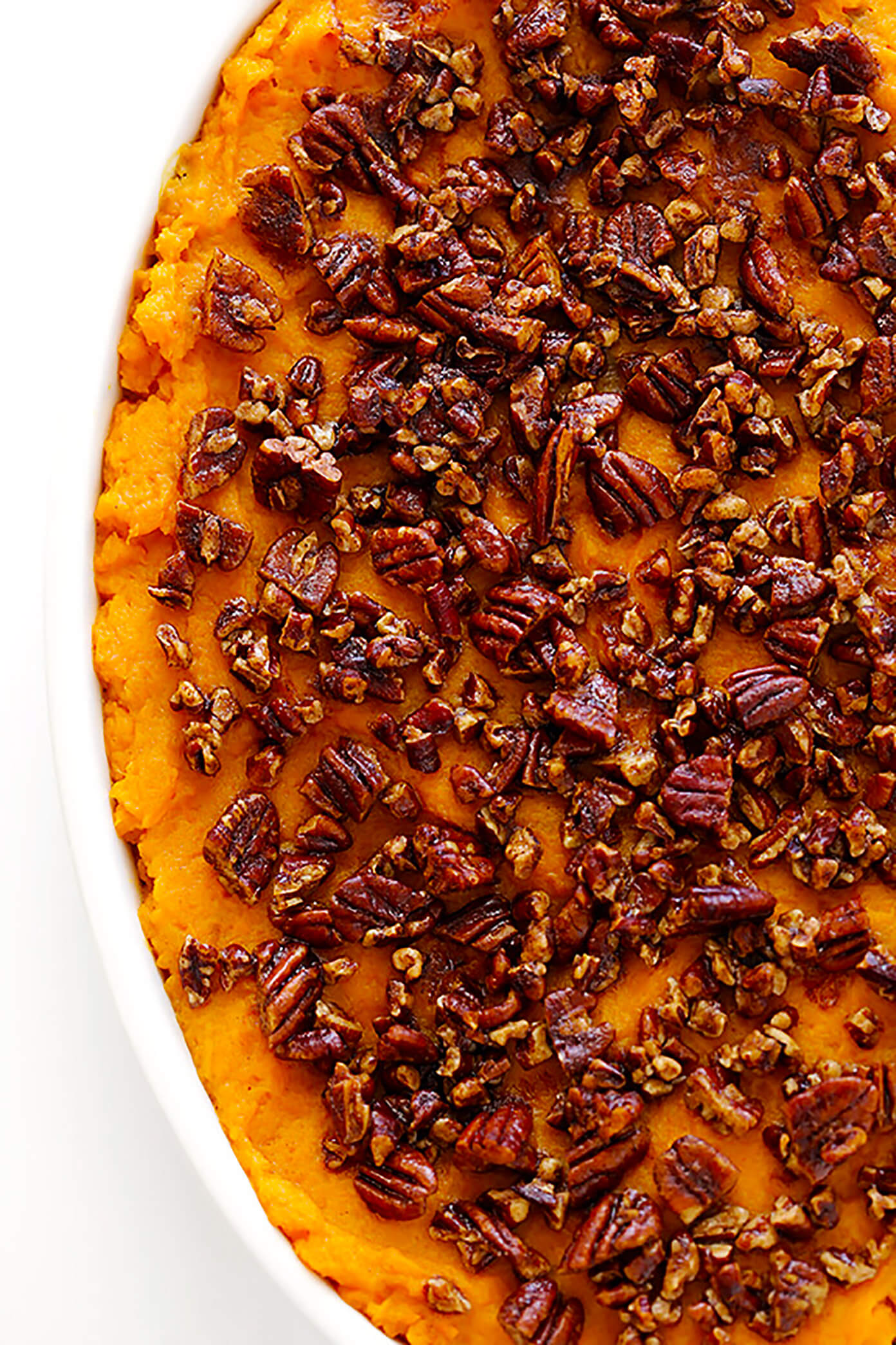 My favorite lightened-up Sweet Potato Casserole recipe! It's topped with delicious pecans, and perfect for Thanksgiving!